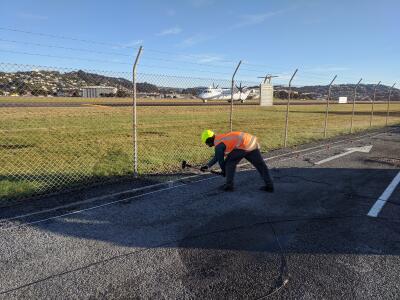Man in hi-vis at Wellington airport.