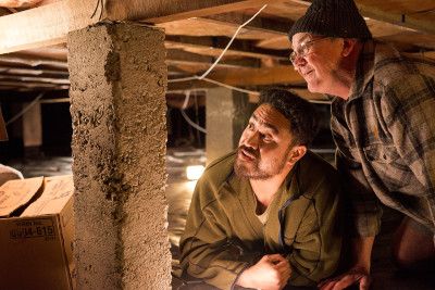 two men checking house foundations