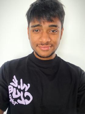 Man smiles at the camera taking a selfie.