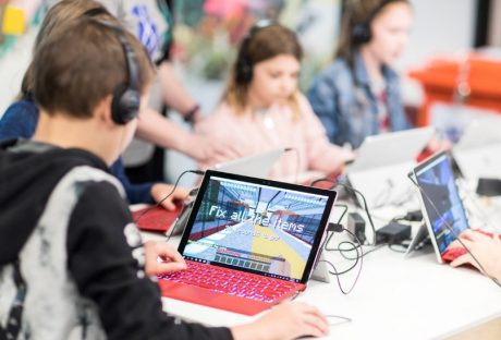 Children sitting at laptops playing the NHC Minecraft shaker mod