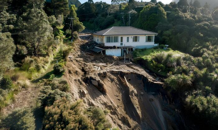 A house teetering on the edge of a landslide