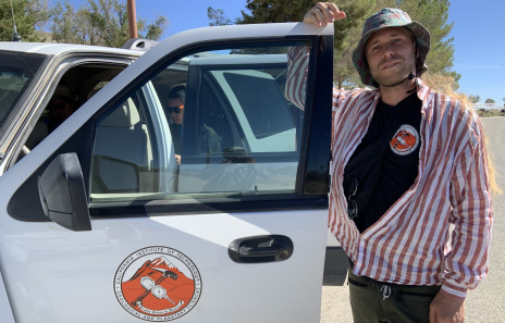 Jesse Kearse stands next to a car during fieldwork at the California Institute for Technology