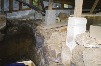A photo of piled foundations under a house.