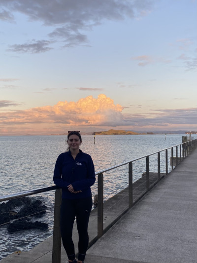 Photo of Meegan standing in front of Motukorea/Browns Island.