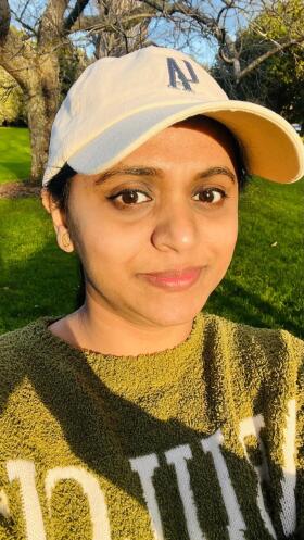 Woman smiles at the camera taking a selfie.