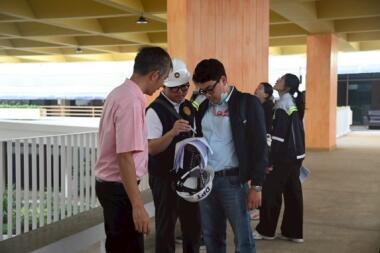Three engineers looking at research findings.